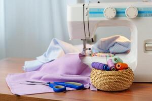 Sewing machine in use on a wooden table, stitching a light fabric in a well-lit indoor workspace photo
