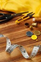 Crafting tools and materials arranged on a wooden table for sewing projects photo