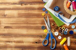 Crafting tools and materials arranged on a wooden table for sewing projects photo