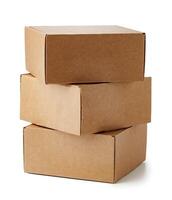 Stacked brown cardboard boxes in various sizes arranged on a white background photo
