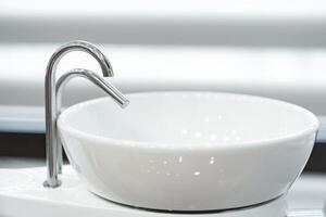 Modern dental workstation featuring an elegant bowl sink and sleek tap design in a well-lit clinic photo