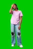 A woman expressing frustration while standing in front of a bright green background photo