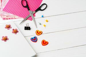 Crafting a colorful workspace with decorations, stationery, and artistic tools on a clean wooden surface photo
