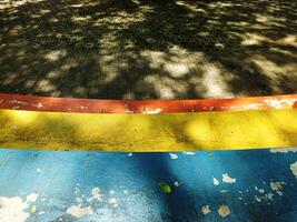 A colorful walkway with a yellow stripe. The walkway is made of bricks and has a yellow stripe photo