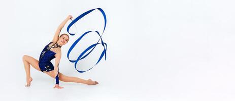 Sports contest. Skilled gymnast in beautiful red leotard performing with string on white background photo