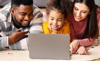 International family on the floor watching laptop and communicate with relatives online during quarantine photo
