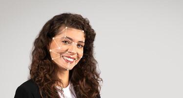 A woman with curly hair smiles at the camera while facial recognition technology maps her features with geometric lines and points, showcasing a modern approach to identity verification. photo