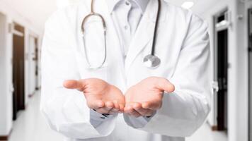 Closeup of unrecognizable doctor holding invisible object on his open palms, standing over white background, cropped image photo