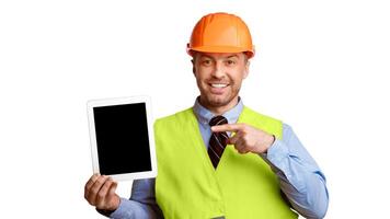 Builder Engineer Guy Showing Digital Tablet Computer Pointing Finger At Empty Screen Standing Over White Background In Studio. Look Here, Online Building Service Ad Concept. Mockup, Panorama photo