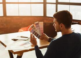 Unrecognizable Designer Guy Working With Color Samples Sitting In Office. Free Space, Selective Focus photo