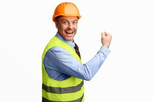 Building success. Excited builder workman gesturing yes in joy smiling to camera posing over white background. Studio shot photo