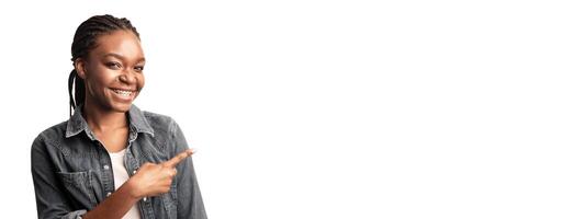 Look There. African Lady With Brackets Pointing Finger Aside At Empty Space Posing On White Studio Background. Panorama photo