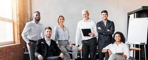 Successful Business Team. Coworkers Smiling To Camera Posing At Workplace In Modern Office. Full Length photo