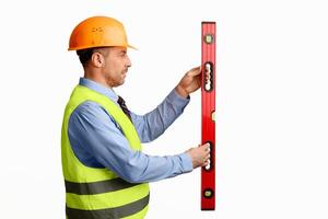 Building Tools. Construction Site Worker Using Builder's Level Working Over White Background. Studio Shot photo