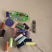 Colorful thread and needle work put on background photo