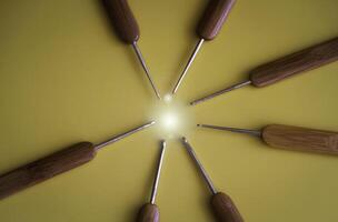 Closeup head of Crochet Hooks point to circle light at the middle of background, photo