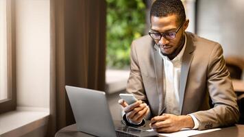 Business Strategy Analysis. Black businessman working on laptop, using smartphone and writing work process in notepad photo