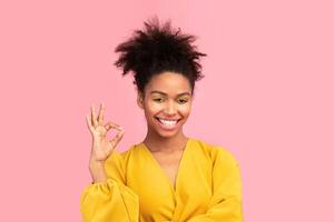 I'm Fine. Happy black girl showing approval ok gesture and smiling isolated over pink studio wall, copyspace, panorama photo