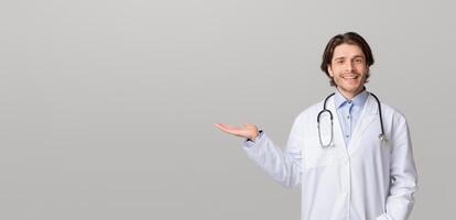 Medical Offer. Smiling male physician pointing aside at copy space with his open palm, demonstrating new pill or treatment, panorama photo