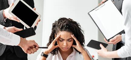 Multitasking And Overworking. Stressed Businesswoman At Laptop Touching Head Tired Of Work Tasks Sitting In Modern Office. photo