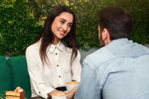 First Date. Girlfriend Smiling Flirting With Boyfriend On Romantic Date In Cafe. Selective Focus photo