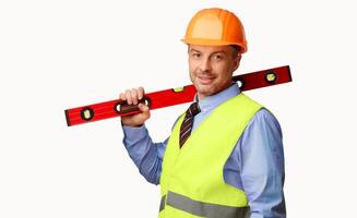 Worker Man Posing With Builder's Level Smiling To Camera Standing In Studio Over White Background. Building Equipment Concept. Copy Space photo
