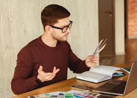 Freelancer Designer Man Working With Color Samples Sitting In Modern Office. Creative Design Job. Selective Focus photo