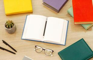 Time To Study. Above view arrangement of educational books on the wooden desk, open notebook with pencil, flat lay photo