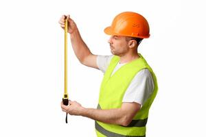 Building Engineer Worker Holding Tape-Measure Posing Standing Over White Background In Studio. Construction Regulations Concept. photo