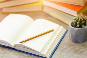 Time To Study. Open notebook lying on wooden desk with pencil on paper, high angle view photo