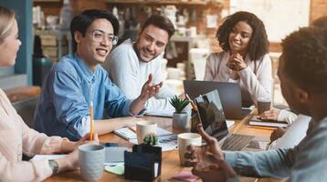 Close up of young creative international group of people having business meeting in office photo