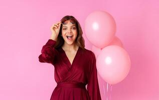 Wow. Surprised Lady Taking Off Glasses And Opening Mouth In Amazement, Holding Balloons While Posing Over Colorful Background, Free Space photo