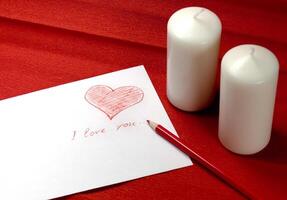 envelope with red heart and two candles photo