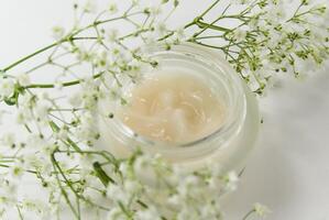 face creme and white flowers photo