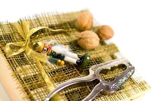nutcracker, walnuts and decorations photo