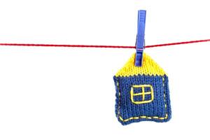 knitted house on a red string photo