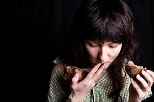 beggar woman eating bread photo