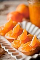 pieces of baguette with orange marmalade photo