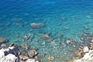 Aerial view of rocks on the sea. Overview of the seabed seen from above, transparent water photo