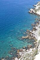 Aerial view of rocks on the sea. Overview of the seabed seen from above, transparent water photo