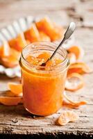 tangerine jam in a glass jar photo