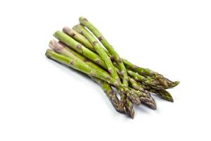 Bunch of fresh raw garden asparagus isolated on white background. Green spring vegetables. photo