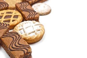 Cake bars filled with cream, oat cookies and tarts with dark chocolate on white background. photo