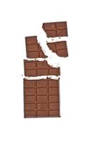 Broken milk chocolate bar wit hazelnuts. photo