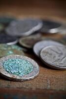 Pile of different ancient copper coins ccloseup on rustic wooden table background. photo