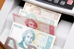 Old Croatian Dinar in the counting machine photo