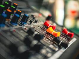Close-up of sound recording equipment knobs.Mixer control. Music engineer. Backstage controls on an audio mixer, Sound mixer. Professional audio mixing console, buttons, faders and sliders photo
