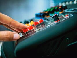 Close-up of sound engineer hands adjusting control sound mixer in recording, broadcasting studio,Sound mixer. Professional audio mixing console, buttons, faders and sliders. sound check. photo