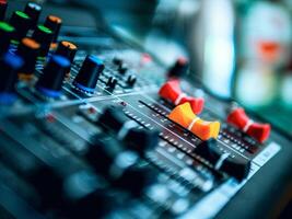 Close-up of sound recording equipment knobs.Mixer control. Music engineer. Backstage controls on an audio mixer, Sound mixer. Professional audio mixing console, buttons, faders and sliders. photo