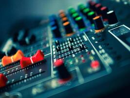 Close-up of sound recording equipment knobs.Mixer control. Music engineer. Backstage controls on an audio mixer, Sound mixer. Professional audio mixing console, buttons, faders and sliders. photo